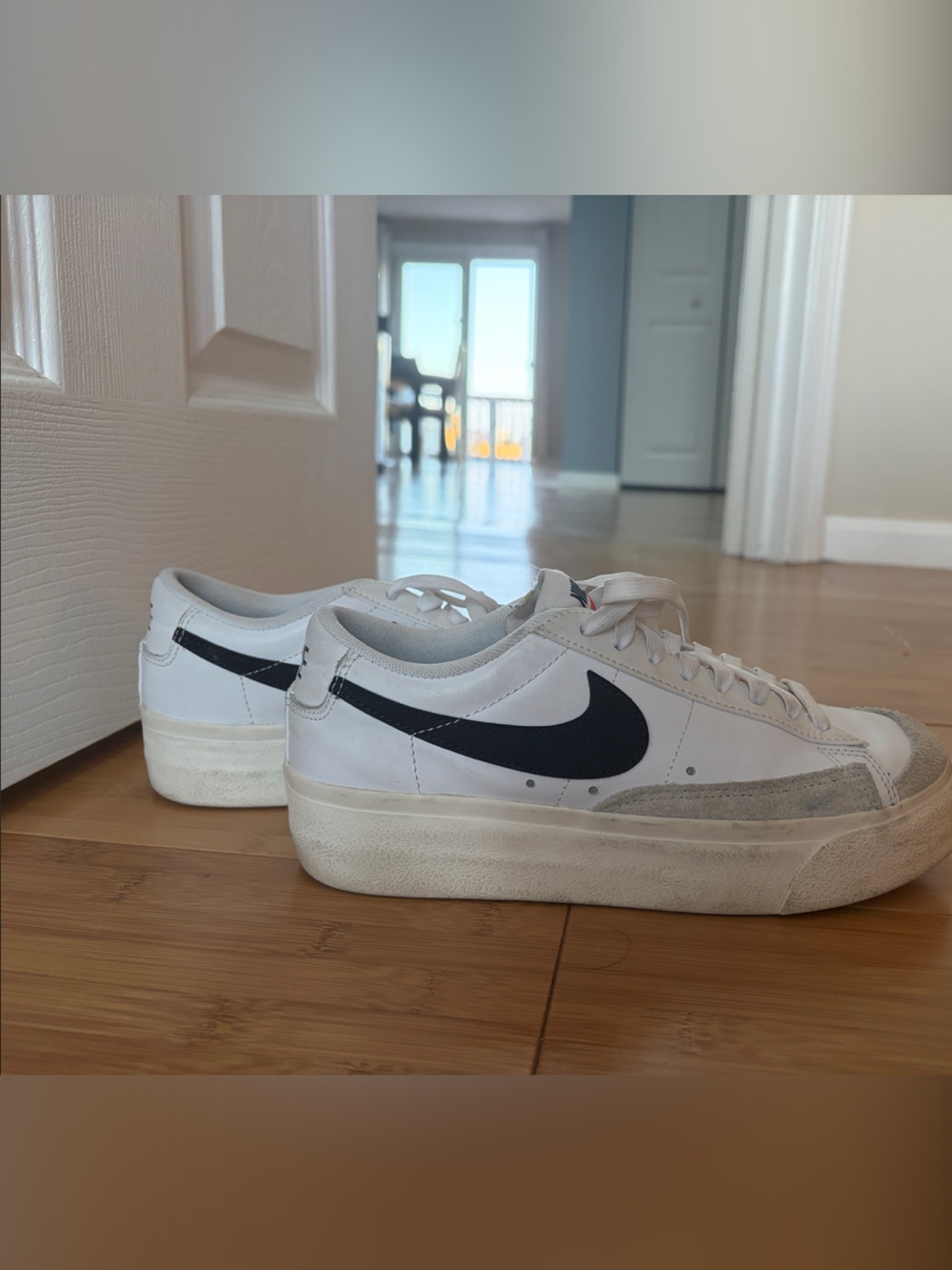 Nike White Low-Top Sneakers with Black Swoosh